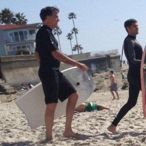 Mitt Romney on his way to catch some waves in La Jolla, California.