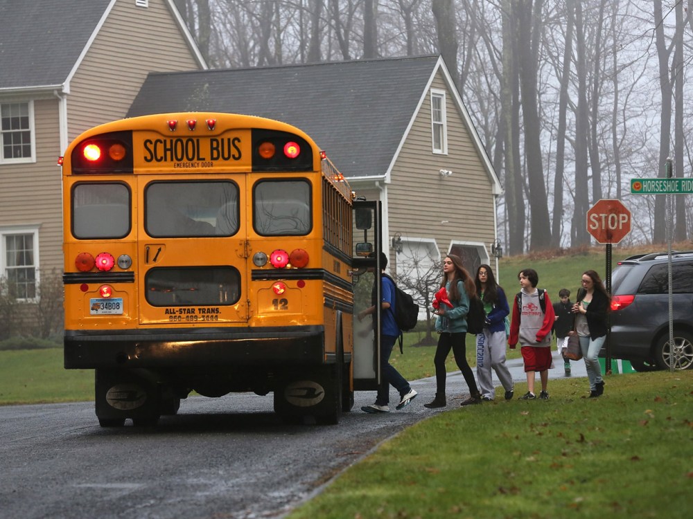 Children return to school on December 18, 2012 in Newtown, Connecticut, four days after the Sandy Hook Elementary massacre. (John Moore/Getty Images)