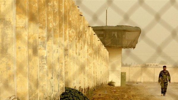 An Iraqi security officer patrols the grounds of Baghdad Central Prison, formerly known as Abu Ghraib.