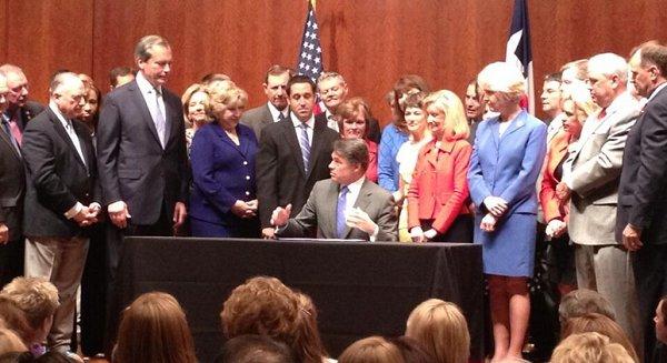 Texas' Perry signs new restrictions on reproductive rights