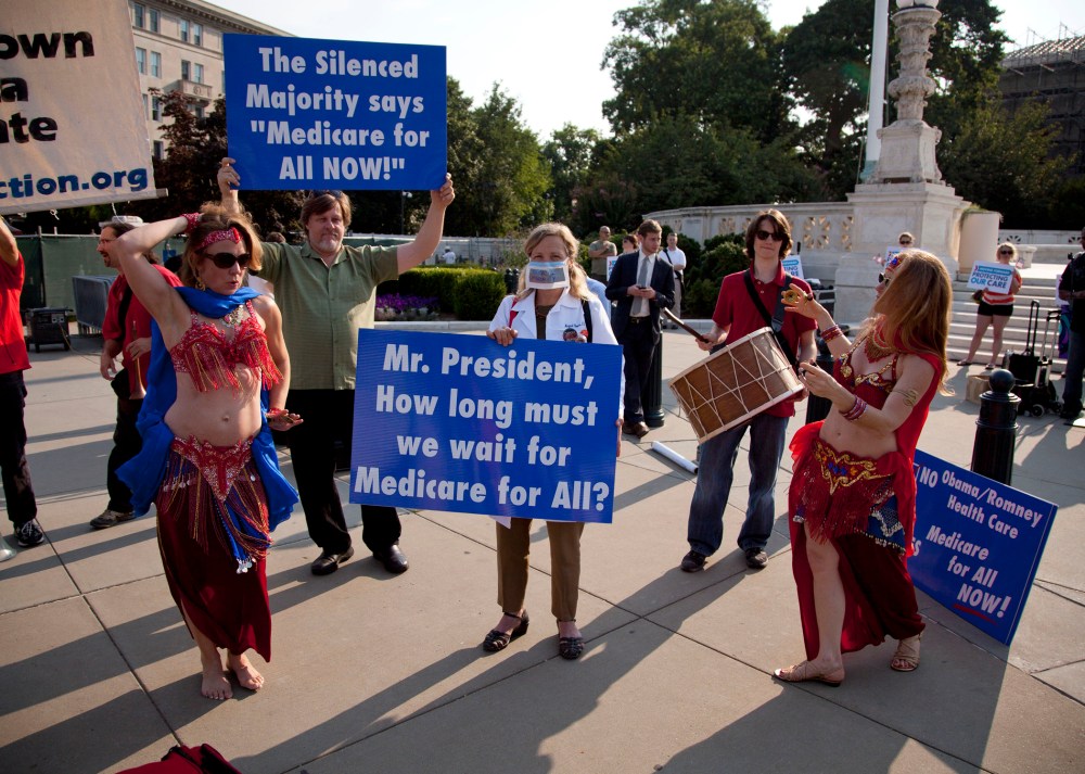 A group of belly dancers in favor of Medicare for all perform outside the Supreme Court in Washington, Thursday, June 28, 2012.