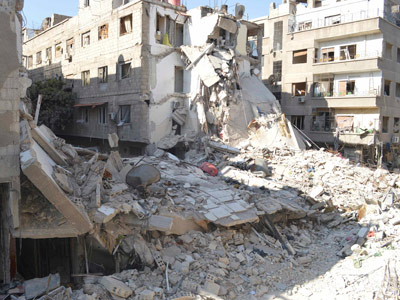 East of Damascus, buildings damaged by what activists said were missiles fired by a Syrian Air Force fighter jet loyal to President Bashar al-Assad