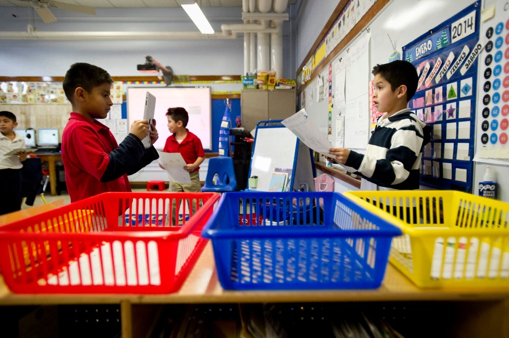 Josue Rodgriquez, 7, (left) records fellow second grader Santiago Gorostieta, 8, as he reads a Spanish-language poster he created at Treadwell Elementary School in Memphis, Tenn., Friday, January 10, 2014.