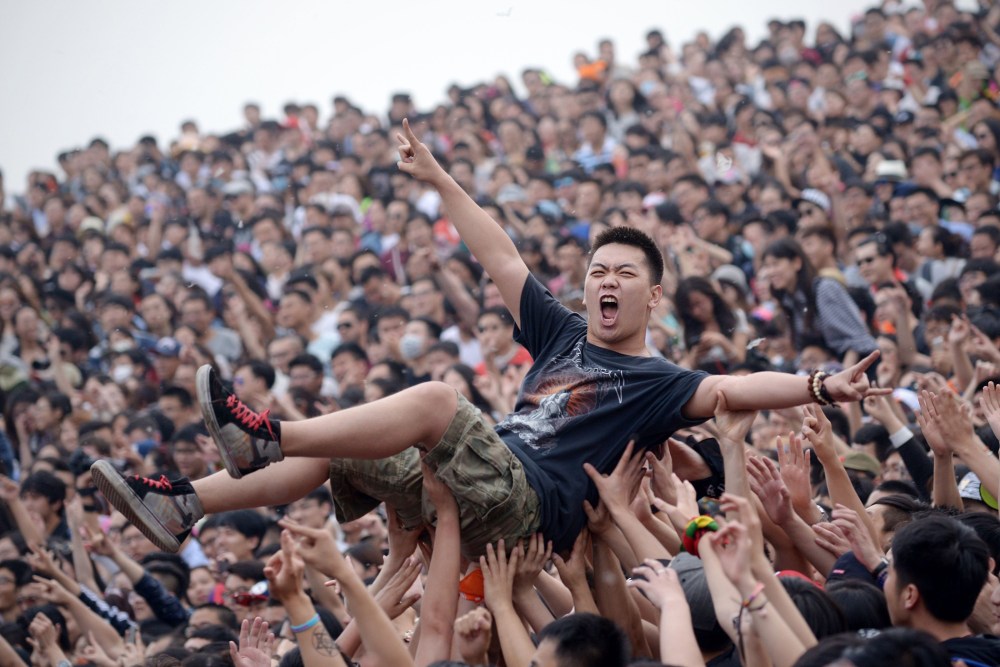 A crowd surfer gestures during the Strawberry Music Festival in Beijing on May 1, 2014.