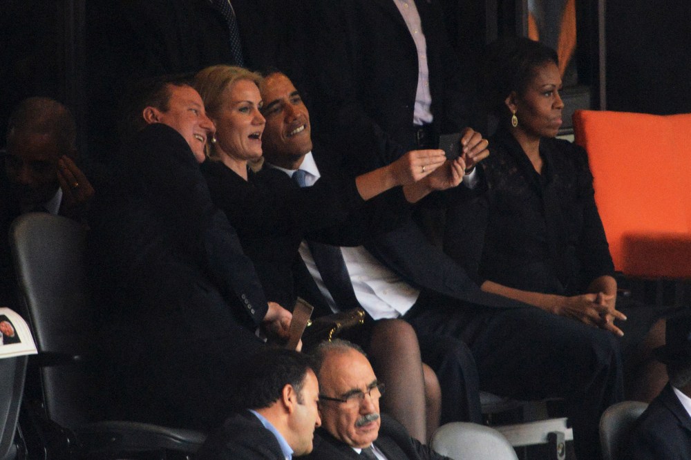 Barack Obama, British Prime Minister David Cameron and Denmark's Prime Minister Helle Thorning Schmidt pose for a picture during the memorial service for Nelson Mandela, Dec. 10, 2013.