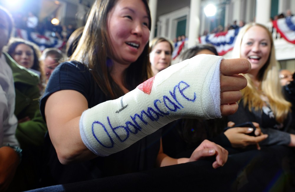 Cathey Park shows her bandaged hand written "I love Obamacare" as she waits to hear US President Barack Obama speaking on healthcare at the Faneuil Hall in Boston, Mass., on Oct. 30, 2013.