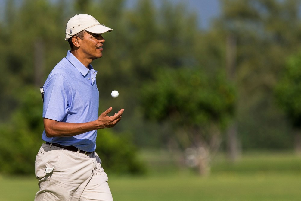 President Barack Obama walks on the second hole green at the Kaneohe Klipper Golf Course at Marine Corps Base Hawaii on January 2, 2014 in Kaneohe, Hawaii.