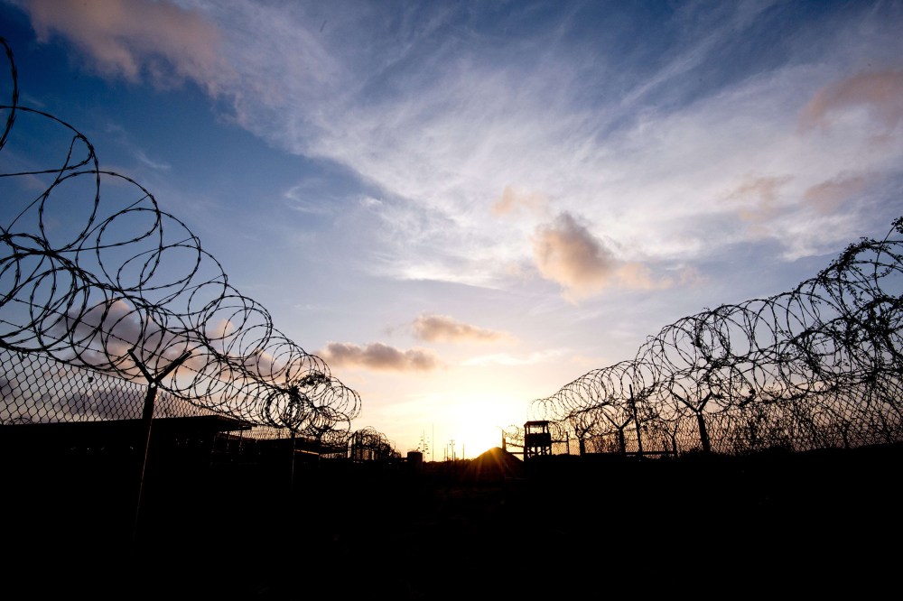 This April 9, 2014 file photo made during an escorted visit and reviewed by the US military, shows the razor wire-topped fence and a watch tower at the abandoned "Camp X-Ray" detention facility at the US Naval Station in Guantanamo Bay, Cuba.
