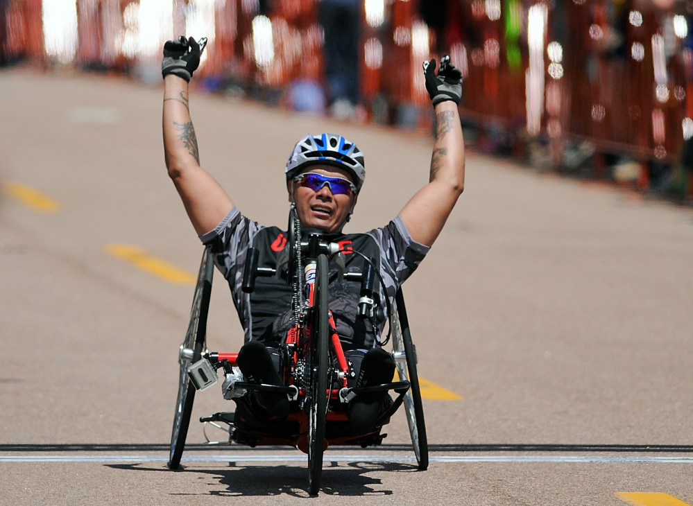 May 12, 2013: Marine Corps wounded warrior, Ronnie Jimenez, celebrates his handcycling victory during the first day of Warrior Games competition at the United States Air Force Academy, Colorado Springs, Colorado. Over 260 injured and disabled service...
