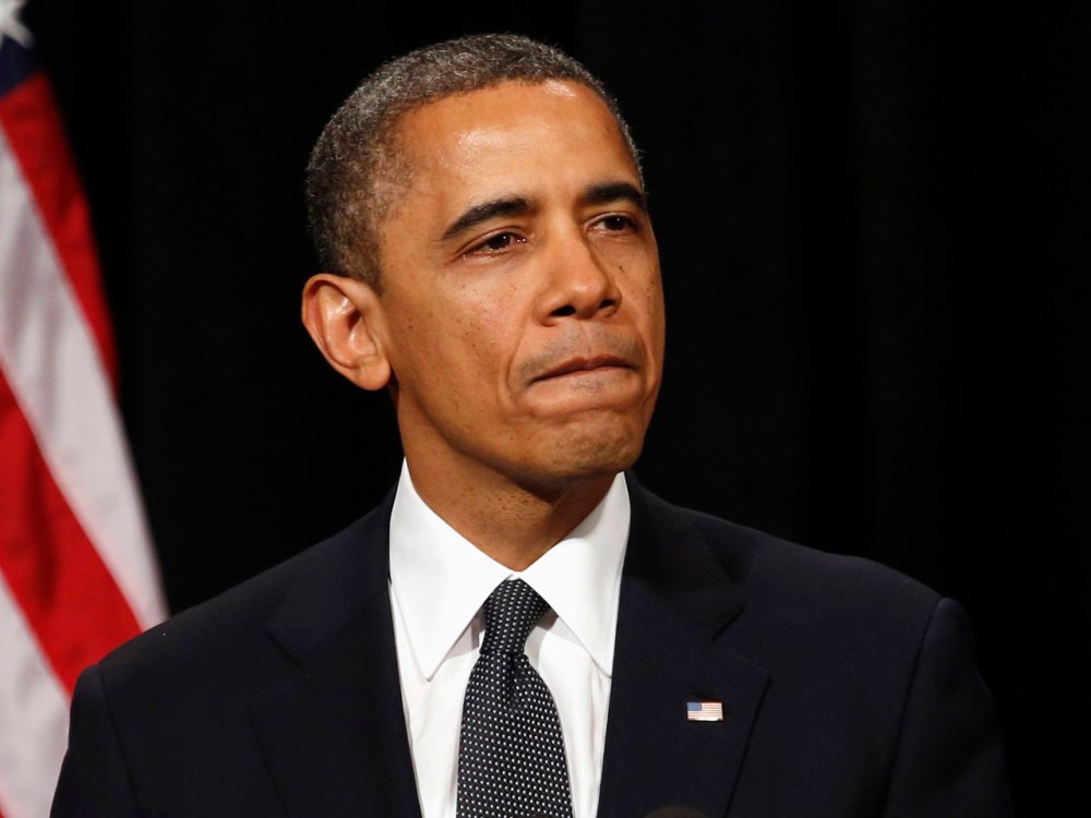 President Obama looks down as he walks from the rostrum after speaking at a vigil held at Newtown High School for families of victims of the Sandy Hook Elementary School shooting in Newtown, Connecticut. (Photo by Kevin Lamarque/REUTERS)
