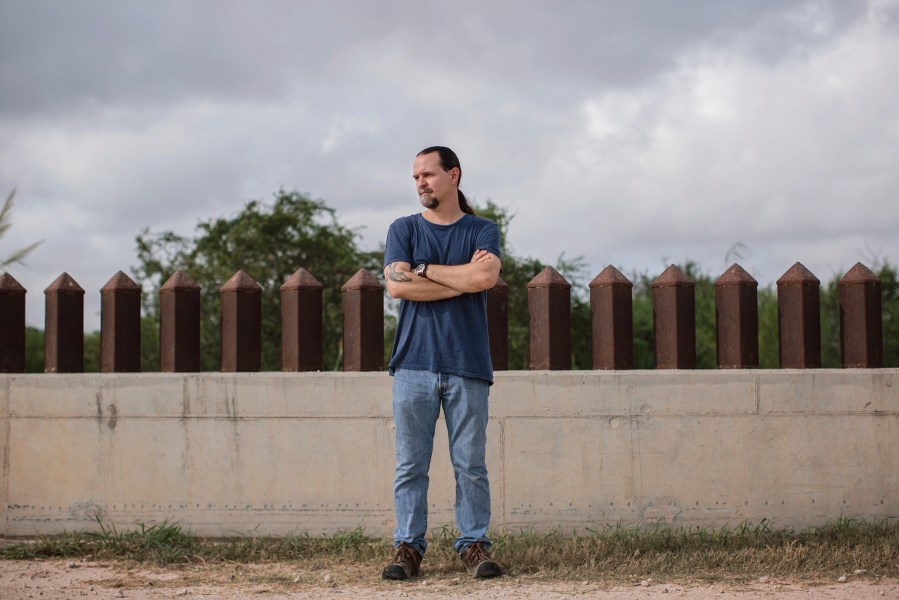 Scott Nicol, an artist and activist pitted against current immigration policy, stands beside the border fence which cuts through fish and wildlife land in Hidalgo, Texas. (Photo by Bryan Schutmaat for MSNBC)