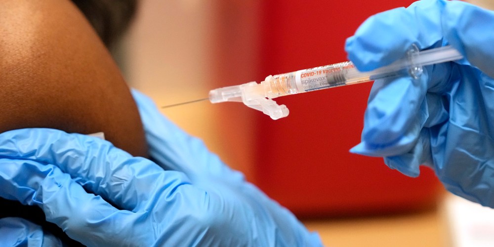 A pharmacist gives a COVID-19 vaccine in Cypress, Texas in 2023.