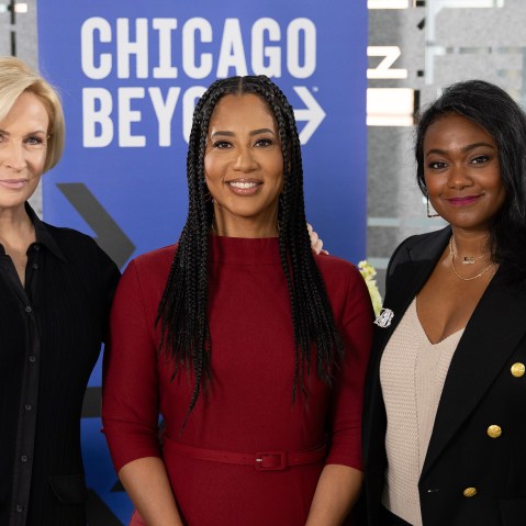 Mika Brzezinski, Liz Dozier, and Tatyana Ali in front of a Chicago Beyond sign.