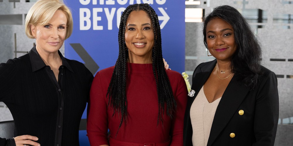 Mika Brzezinski, Liz Dozier, and Tatyana Ali in front of a Chicago Beyond sign.