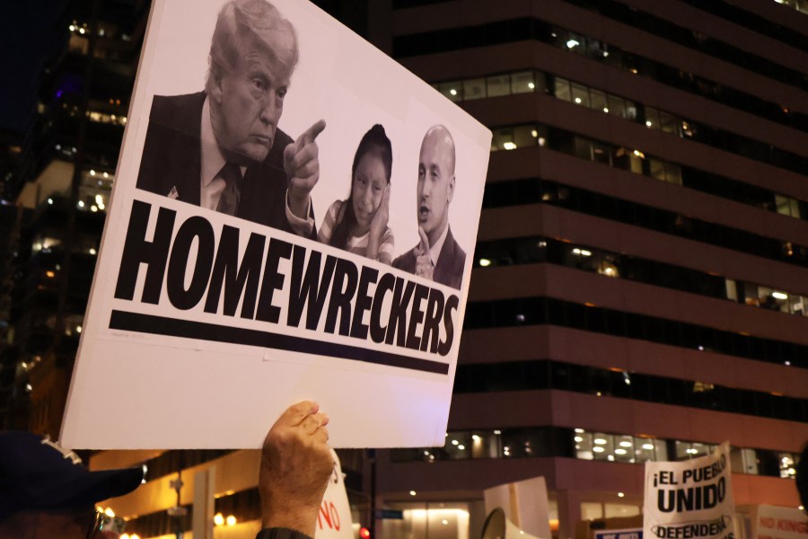 Protester holding up sign during an anti-ICE protest in Chicago.