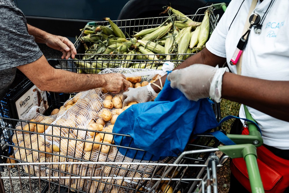 Volunteers pack bags of groceries to distribute to the local community for their daily food pantry in Philadelphia, P.A.
