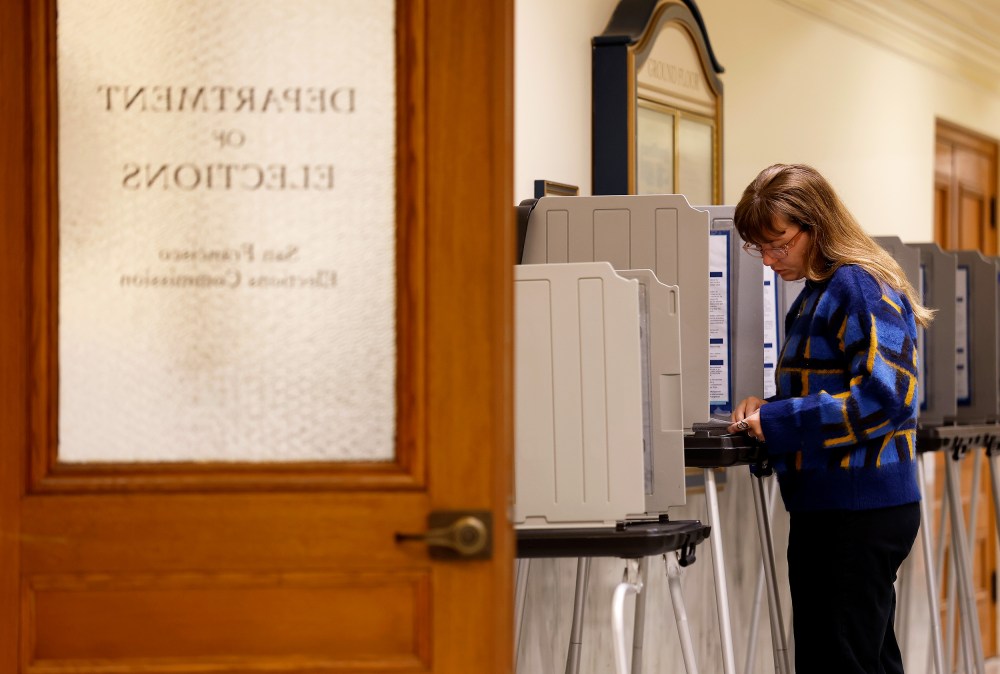 A voter fills out their ballot inside San Francisco City Hall.