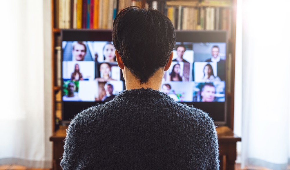 Woman in front of a device screen in video conference for work.
