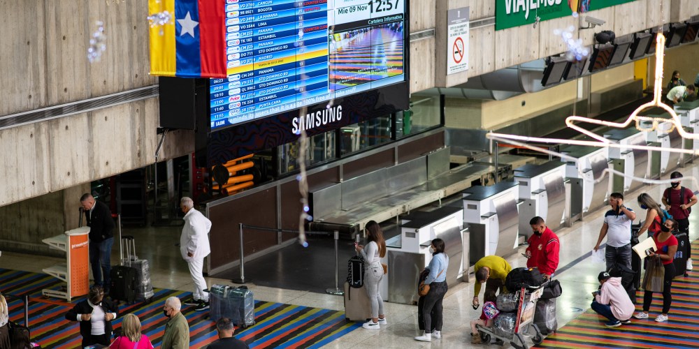 Travelers wait in line to check in for flights at the Simón Bolívar International Airport in Venezuela.