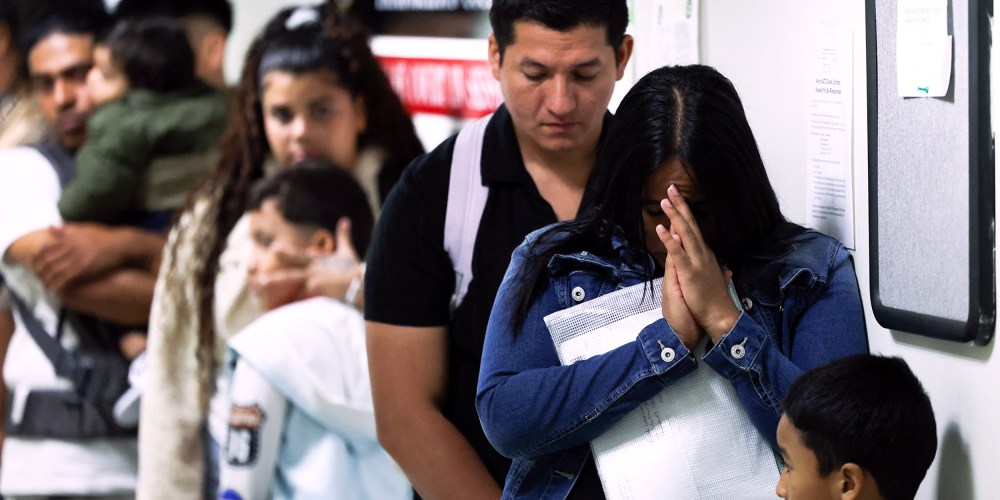 People wait in line before their hearings at the New York Federal Plaza Immigration Court in New York City.