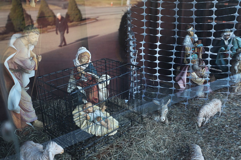 In 2018, the nativity scene at St. Susanna Parish in Dedham, M.A., included baby Jesus inside a black metal cage.