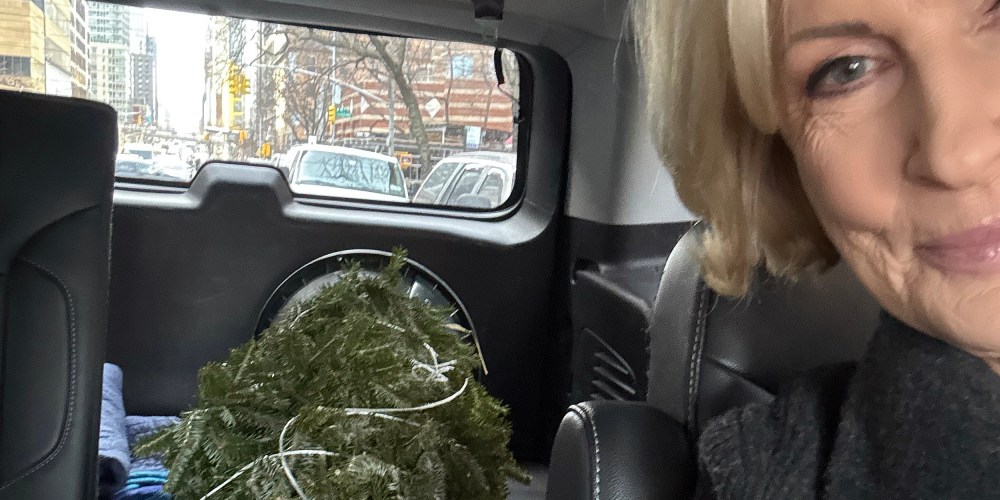 Mika Brzezinski in her car with the Christmas Tree she bought.