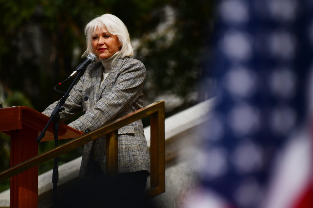 Tina Peters is in the rally in front of the Colorado State Capitol building in Denver.