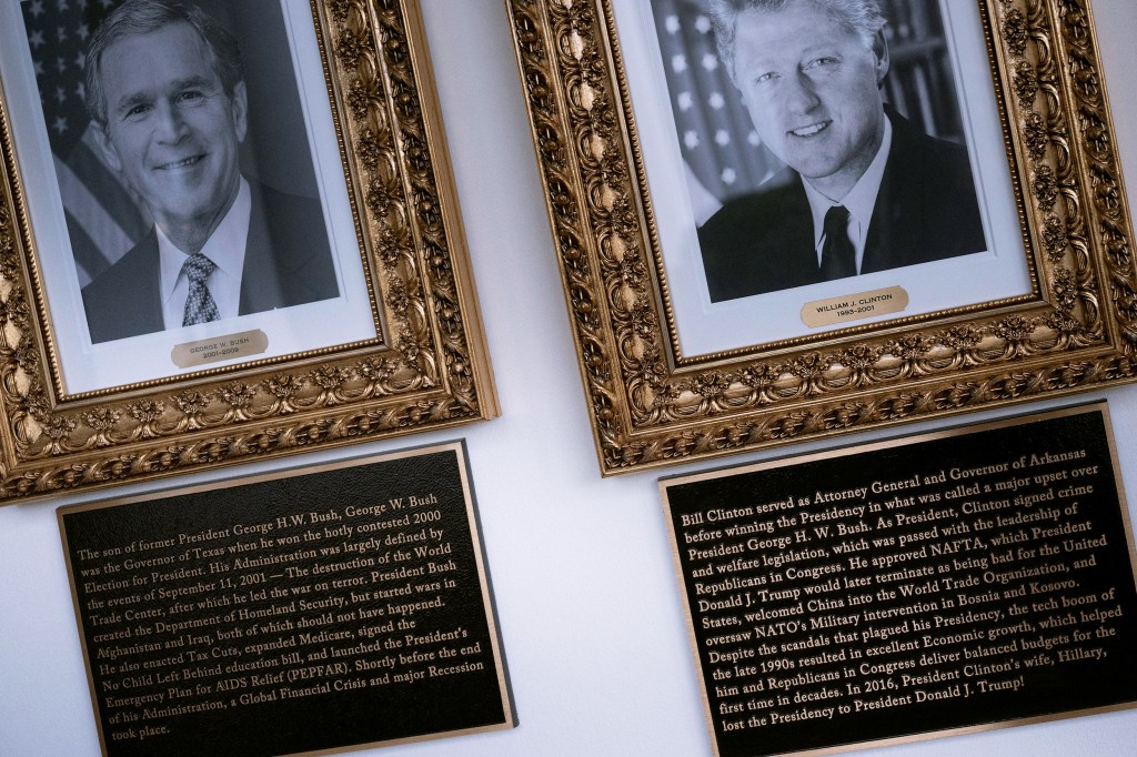 George H. W. Bush and Bill Clinton's photos and plaques on "The Presidential Walk of Fame" outside the White House on Dec. 17, 2025.