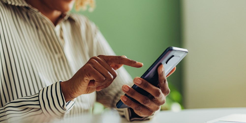 African American woman using social media on her phone.
