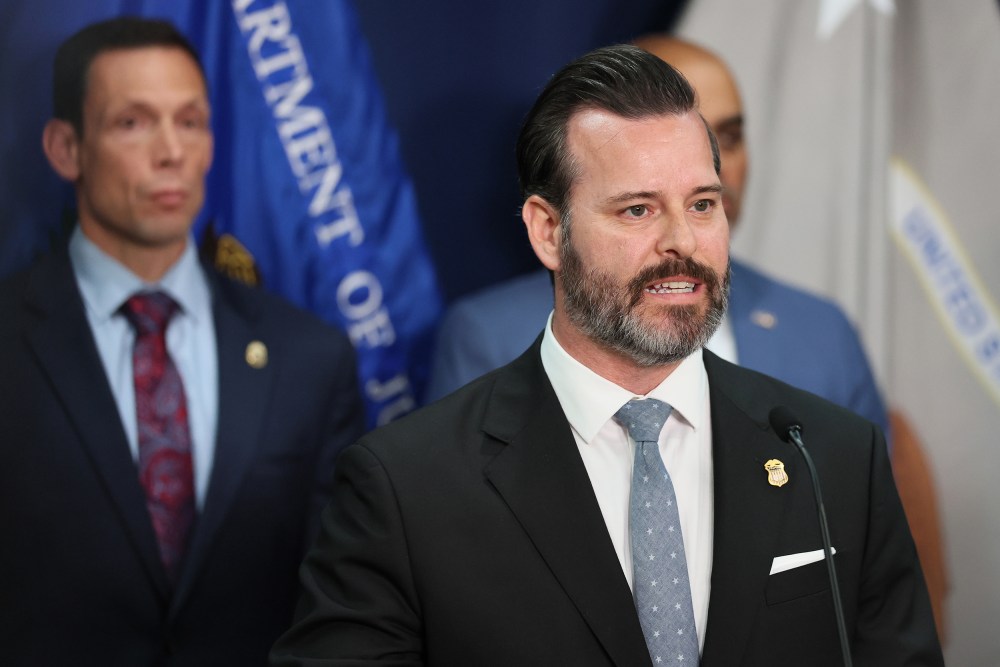 Jason A. Reding Quiñones speaks into a microphone.