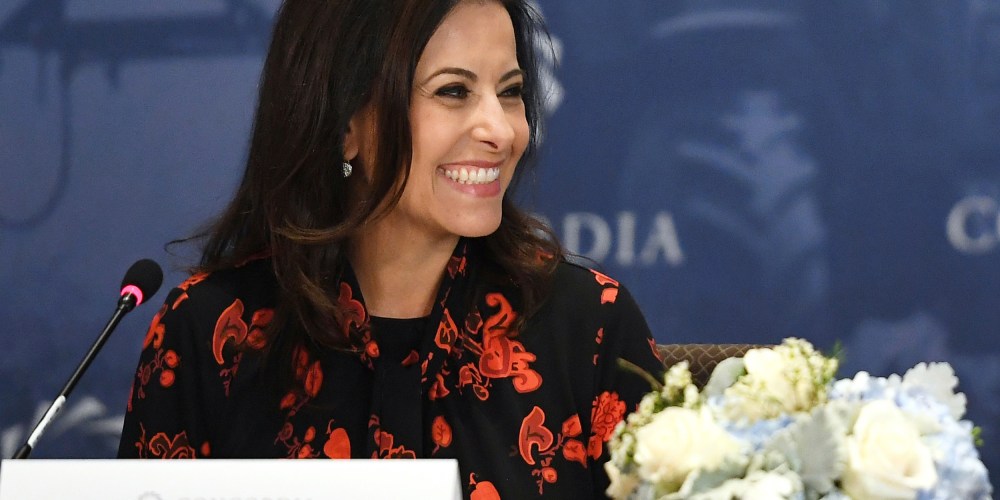 Dina Powell McCormick smiles.