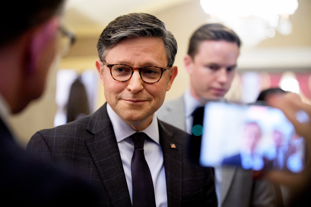 Speaker of the House Mike Johnson speaks with reporters filming him on their phones.