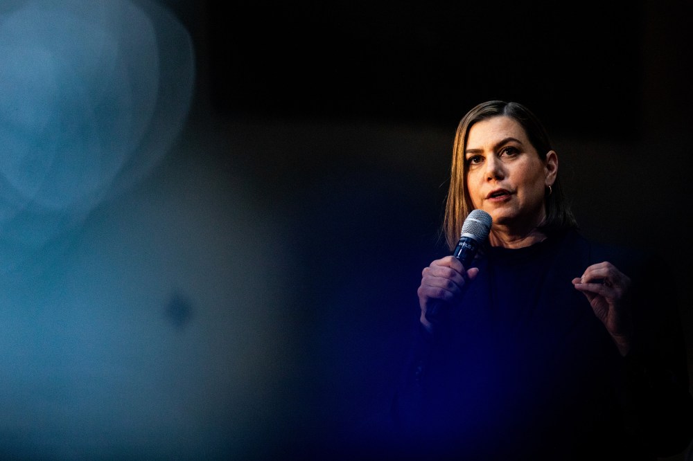 Senator Elissa Slotkin holds a microphone.