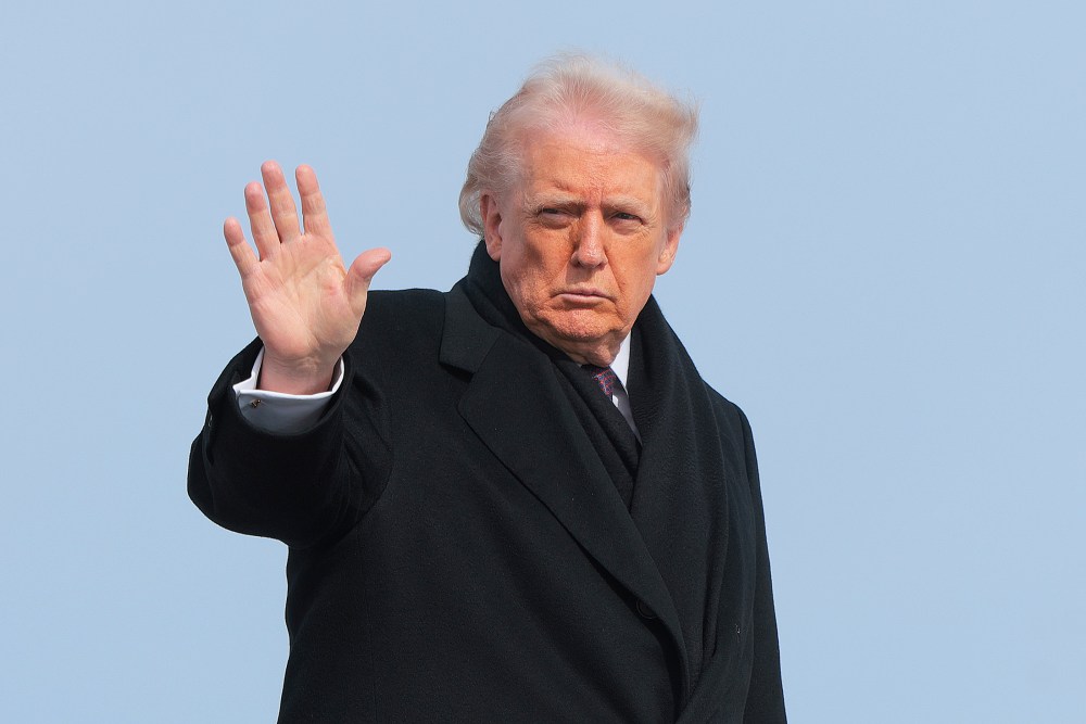 President Donald Trump waves as he boards Air Force One.