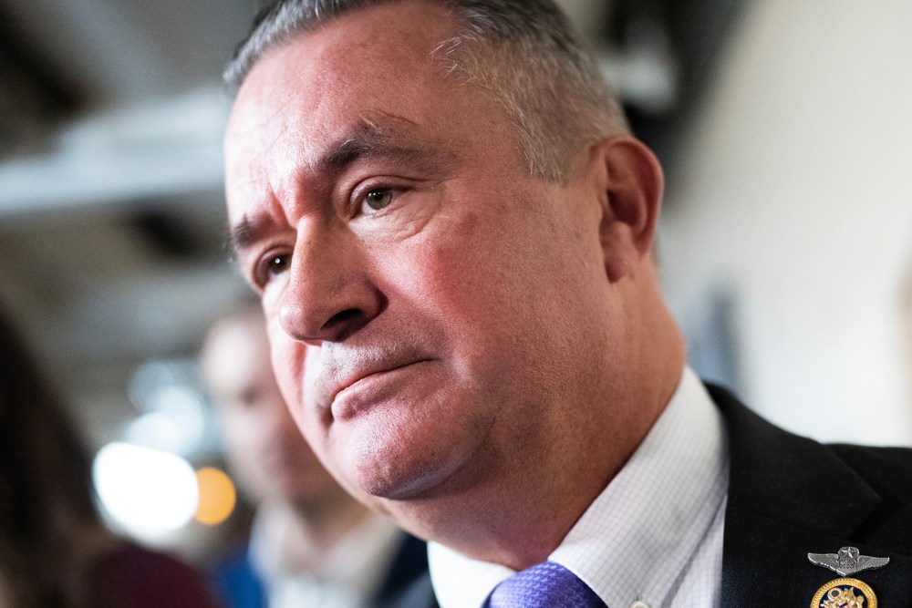 Republican Rep. Bacon stands in front of reporters, seen in a very tight shot of his face.