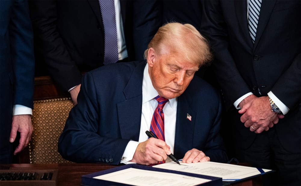 President Donald Trump signing an act on July 18, 2025, during a ceremony in the East Room of the White House.