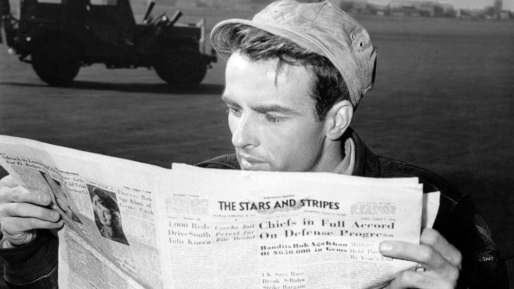 American actor Montgomery Clift reading a copy of 'The Stars and Stripes' in Berlin circa 1950.