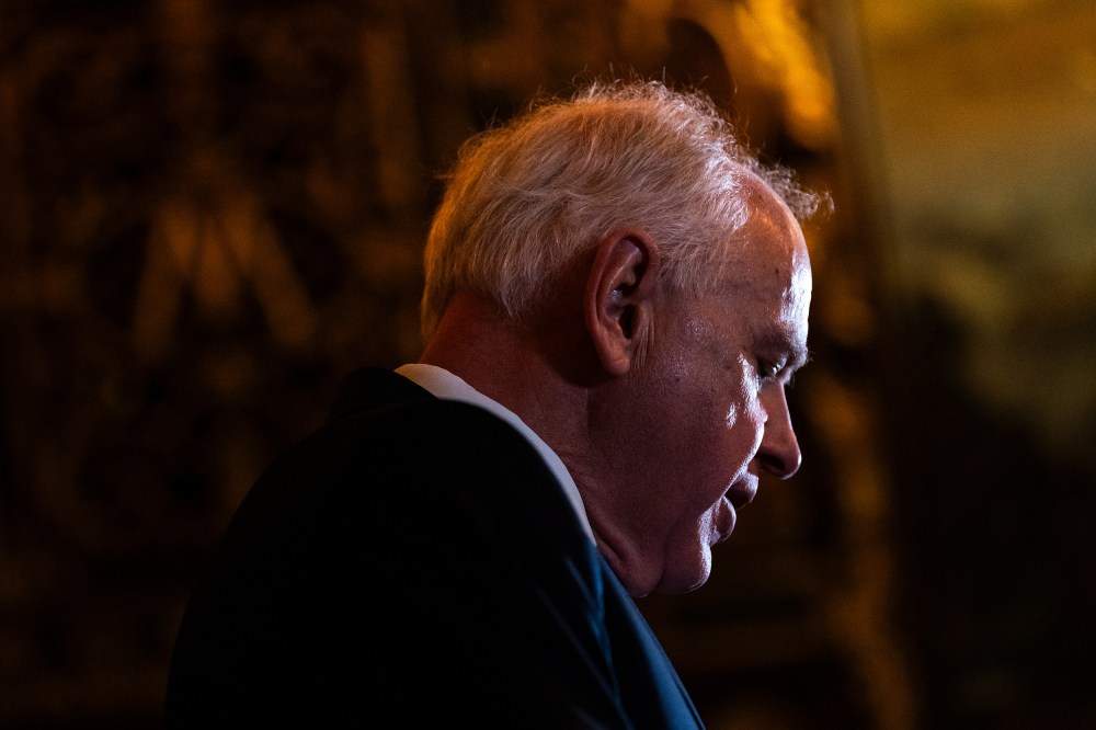 Tim Walz's profile, looking down.