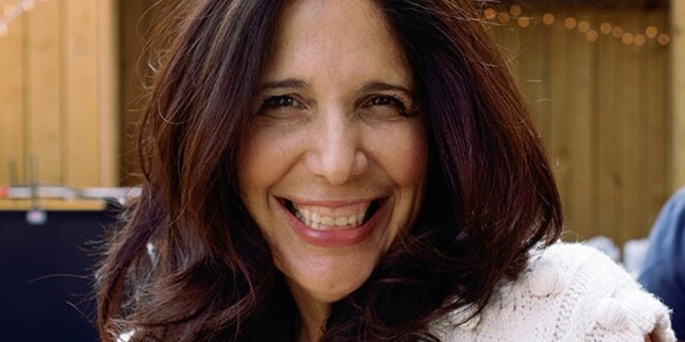 Sue Zarco Kramer smiles at an outside venue.