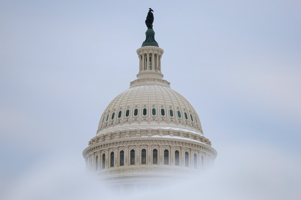 Snow frames the dome of the Capitol.