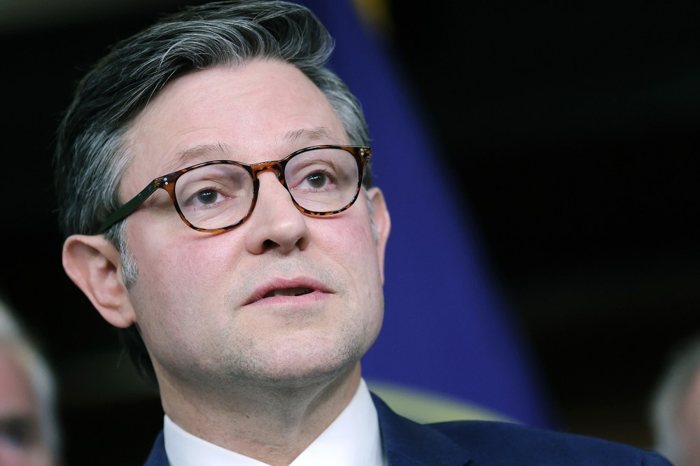 Mike Johnson speaking to the journalists in a very closeup frame. Photo is shot from below.