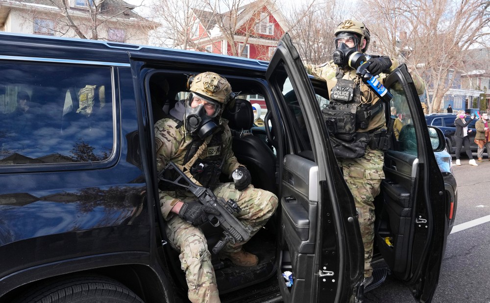 Federal agents get ready to disperse tear gas into a crowd at a protest on Jan. 12, 2026 in Minneapolis.