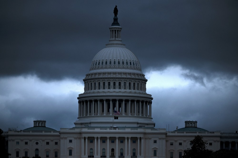 The Capitol building with dark, ominous clouds in the background.