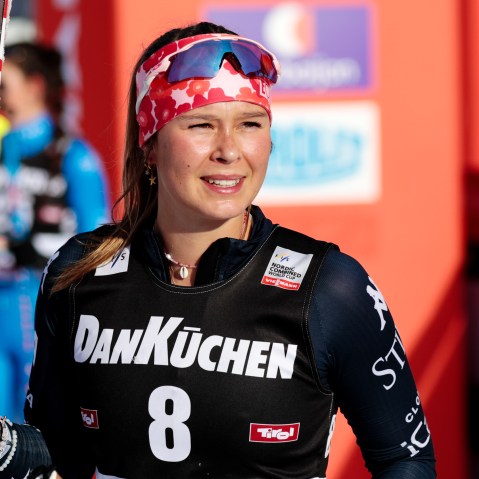 Annika Malacinski smiles with her ski outside.