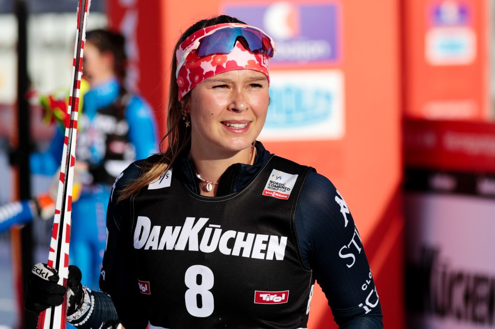 Annika Malacinski smiles with her ski outside.