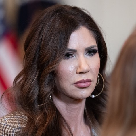 Kristi Noem speaks to another person.