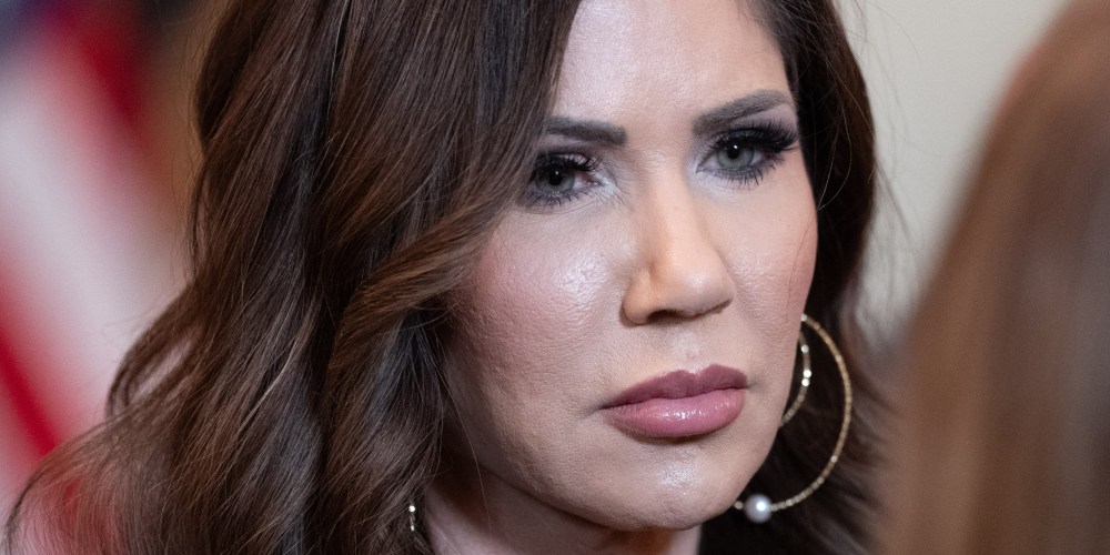 Kristi Noem speaks to another person.