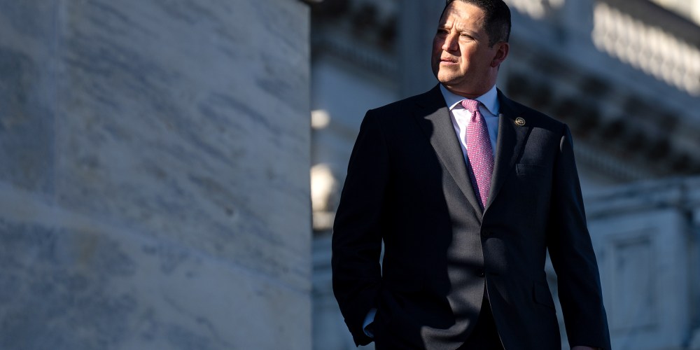 Tony Gonzales looks away as he walks down the steps where a small part of his face is in shade.