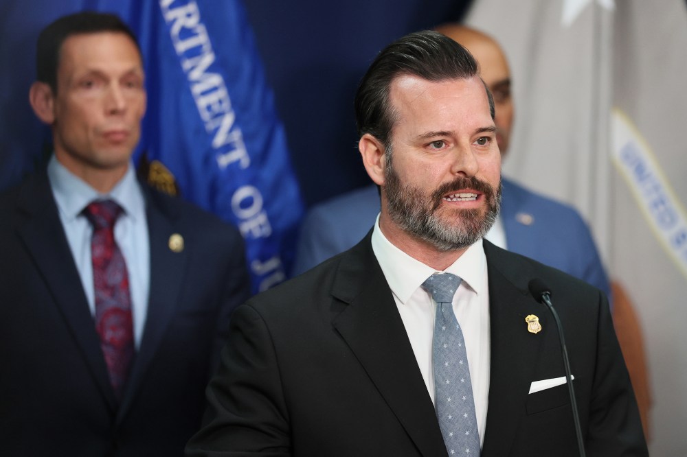 Jason Reding Quiñones speaks into a microphone.