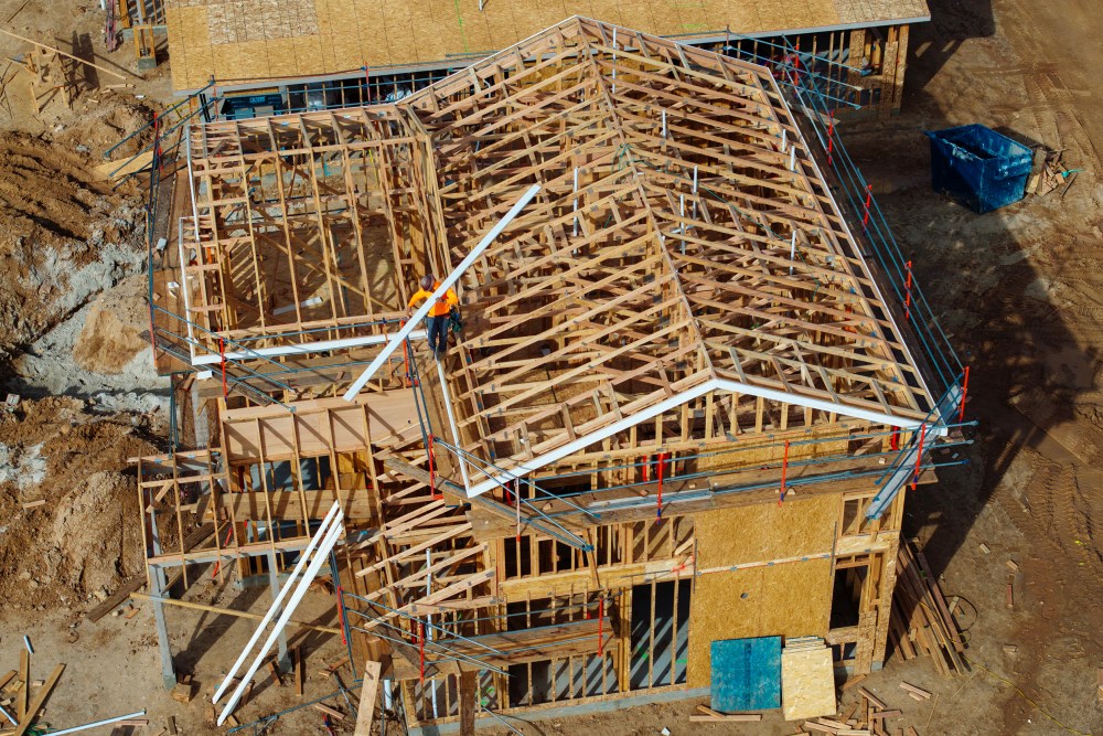 An aerial shot shows a house skeleton that is being built.